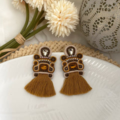 Aretes hecho a mano marron flecos dorados
