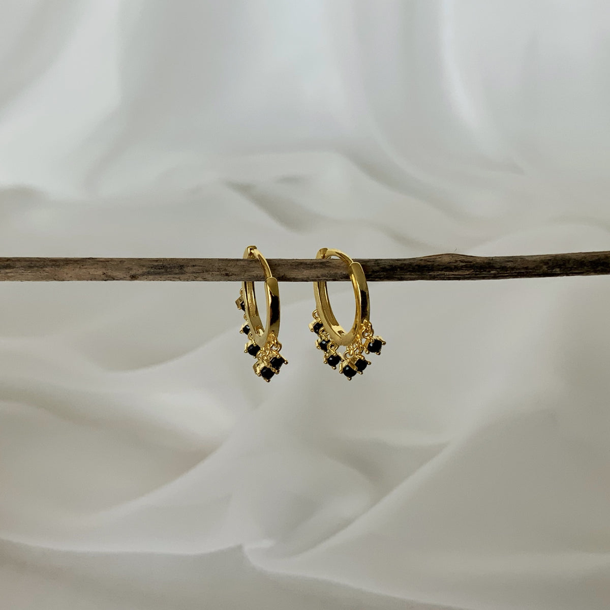 Mini argollas lluvia de circones negros en plata 925 bañado en oro 18k