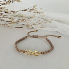 Pulsera de hilo ajustable nude con infinito dorado con circones